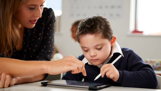 A child happily using a Samartya learning app on an iPad