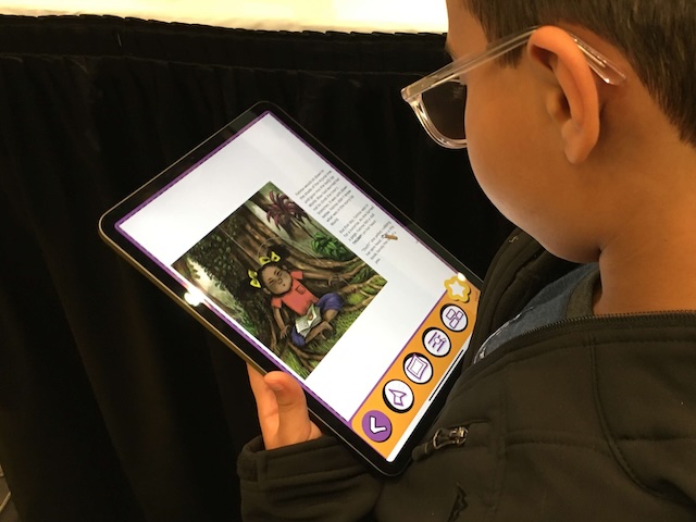 A child using the Dyslexia Reader app on an iPad to read a story